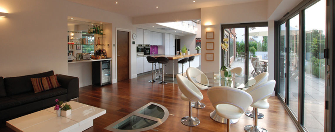 Open-plan kitchen extension in a Sevenoaks family home featuring a glass roof, bi-fold doors and bespoke joinery by Simon King Construction